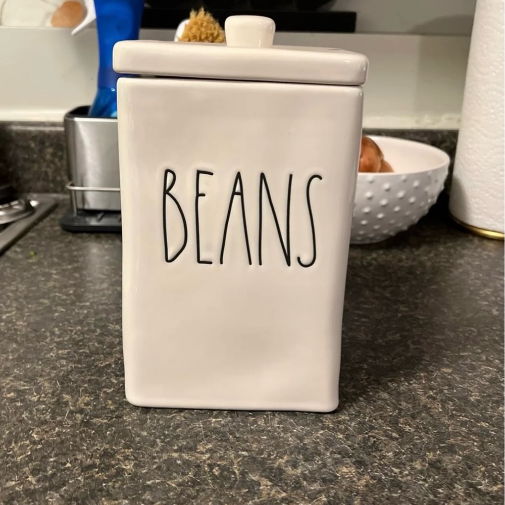 Brand new, never used Rae Dunn large bean canister, white with black writing.